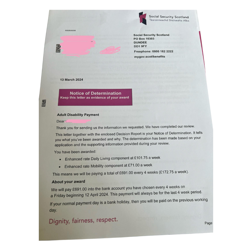 Example photo of a Scottish Adult or Child Disability Payment letter with the whole page in frame.